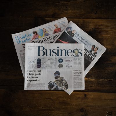 A newspaper with the words business on it.