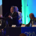 Jim Dehem accepting the David LaLumia Award A man in a suit speaking at a podium.